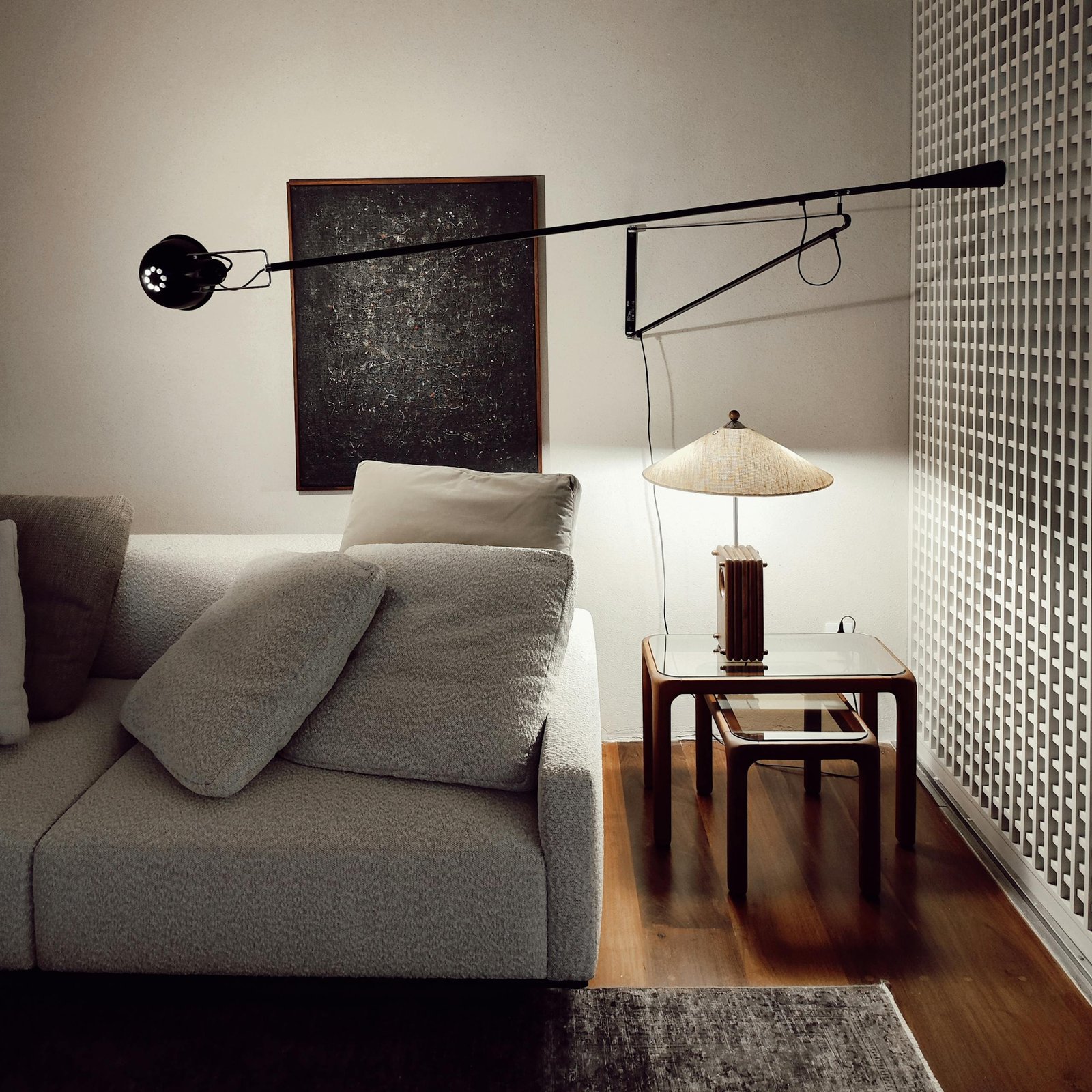 A warm and inviting modern living room featuring a cozy sofa, artistic lamp, and stylish decor.