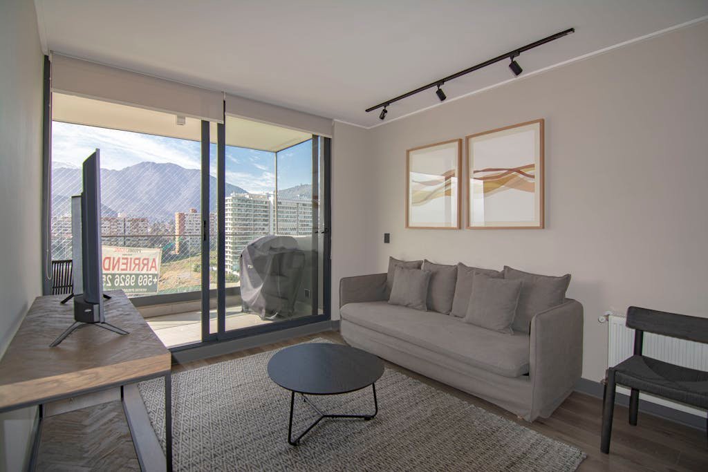 Contemporary living room featuring a cozy sofa, stylish decor, and stunning mountain view.