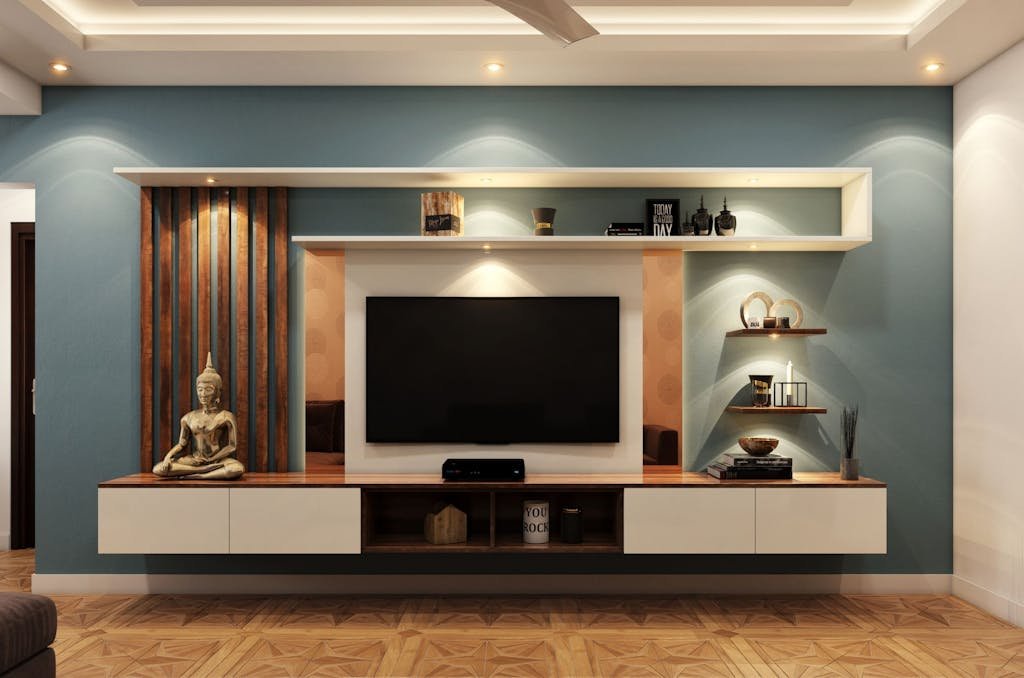 Elegant minimalist living room with TV, decorative shelves, and Buddha statue for serene ambiance.